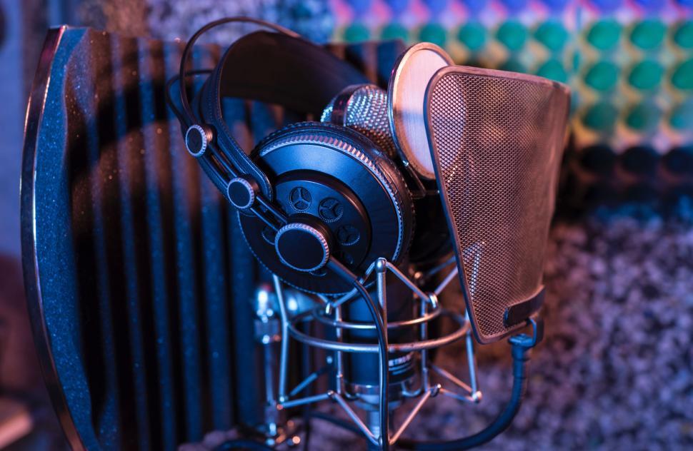 Free Image of Headphones Resting on Microphone 