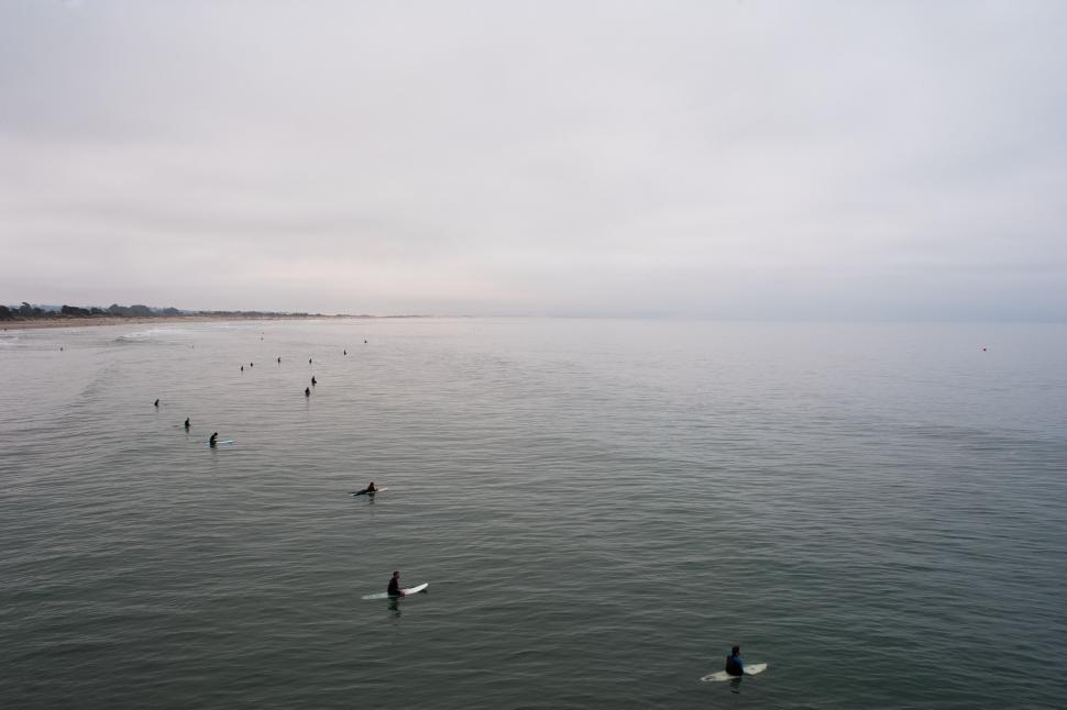 Free Image of Group of People Riding Surfboards on Top of Water 
