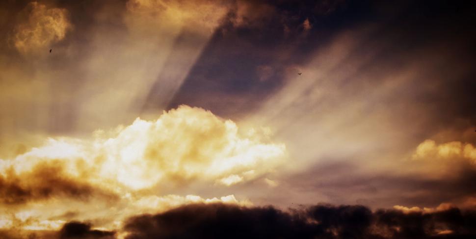 Free Image of Sun Shining Through Clouds in Sky 