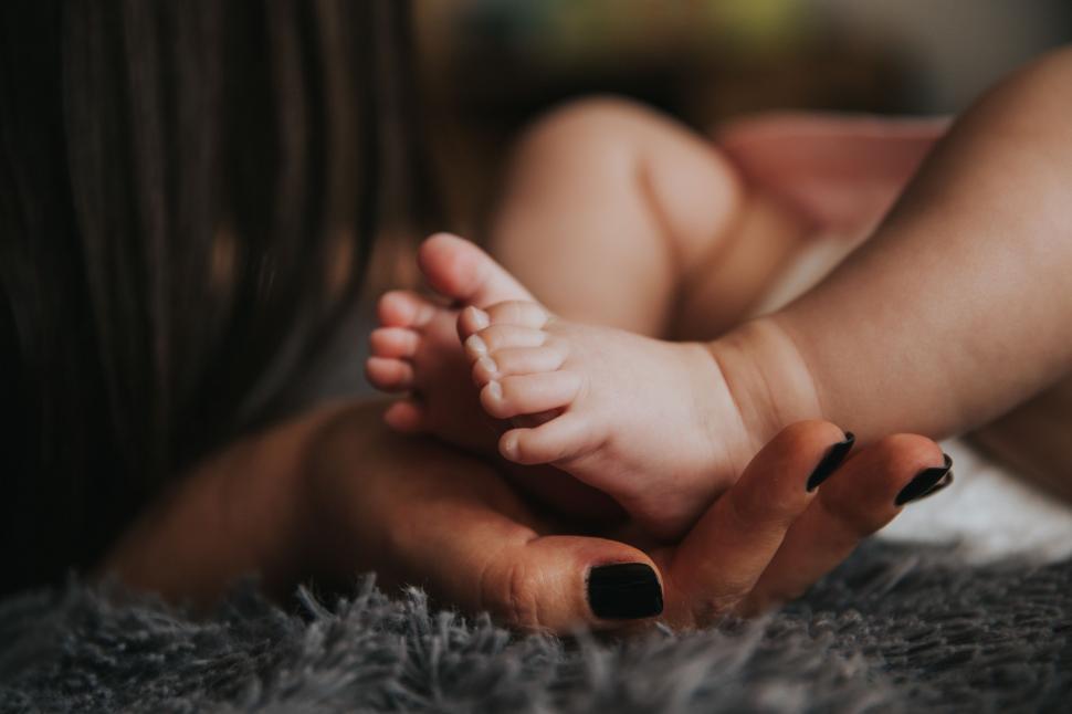 Free Image of Woman Holding A Baby In Her Arms 