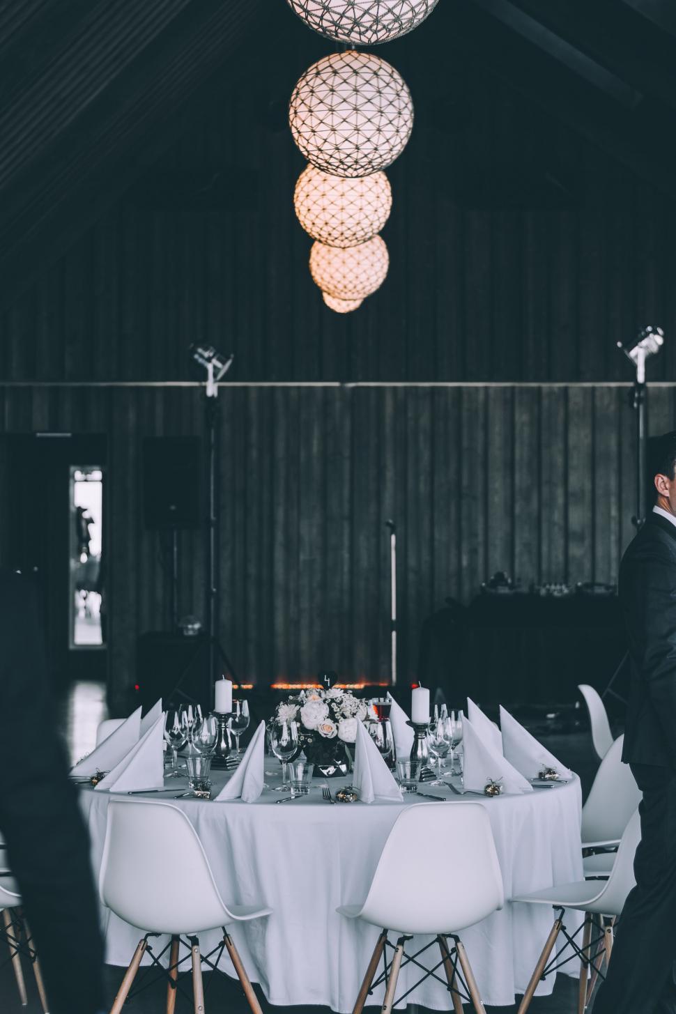 Free Image of Couple Standing in Front of Table 