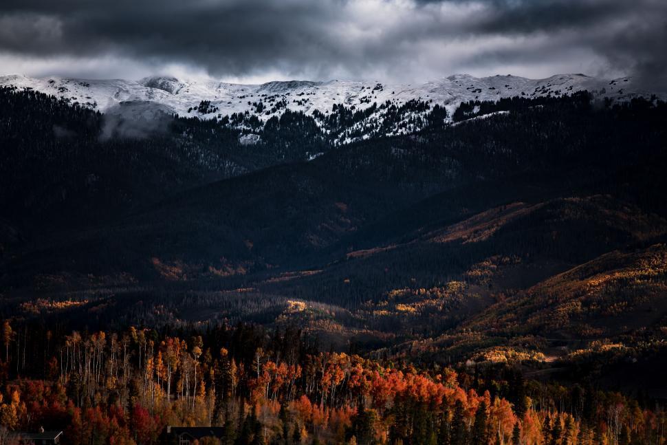 Free Image of Snow Covered Mountain Range Under Cloudy Sky 