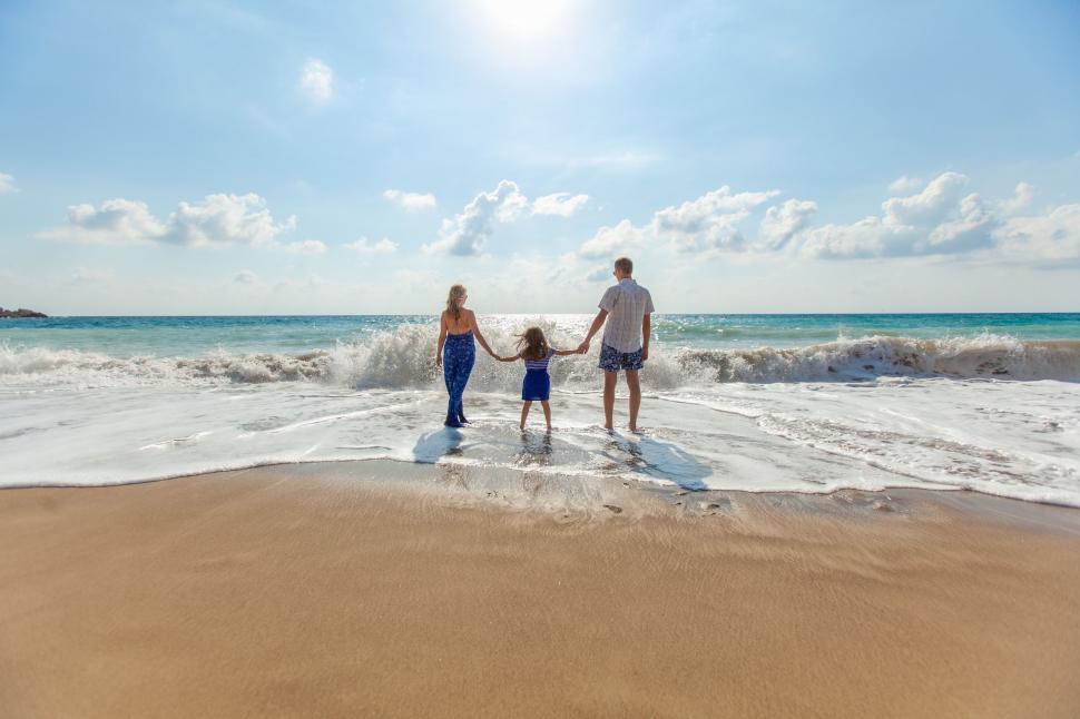 Free Image of Man and Woman Holding Hands Walking on Beach 