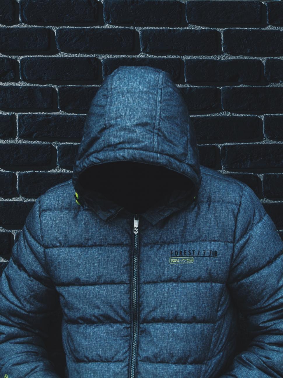 Free Image of Person Standing in Front of Brick Wall 