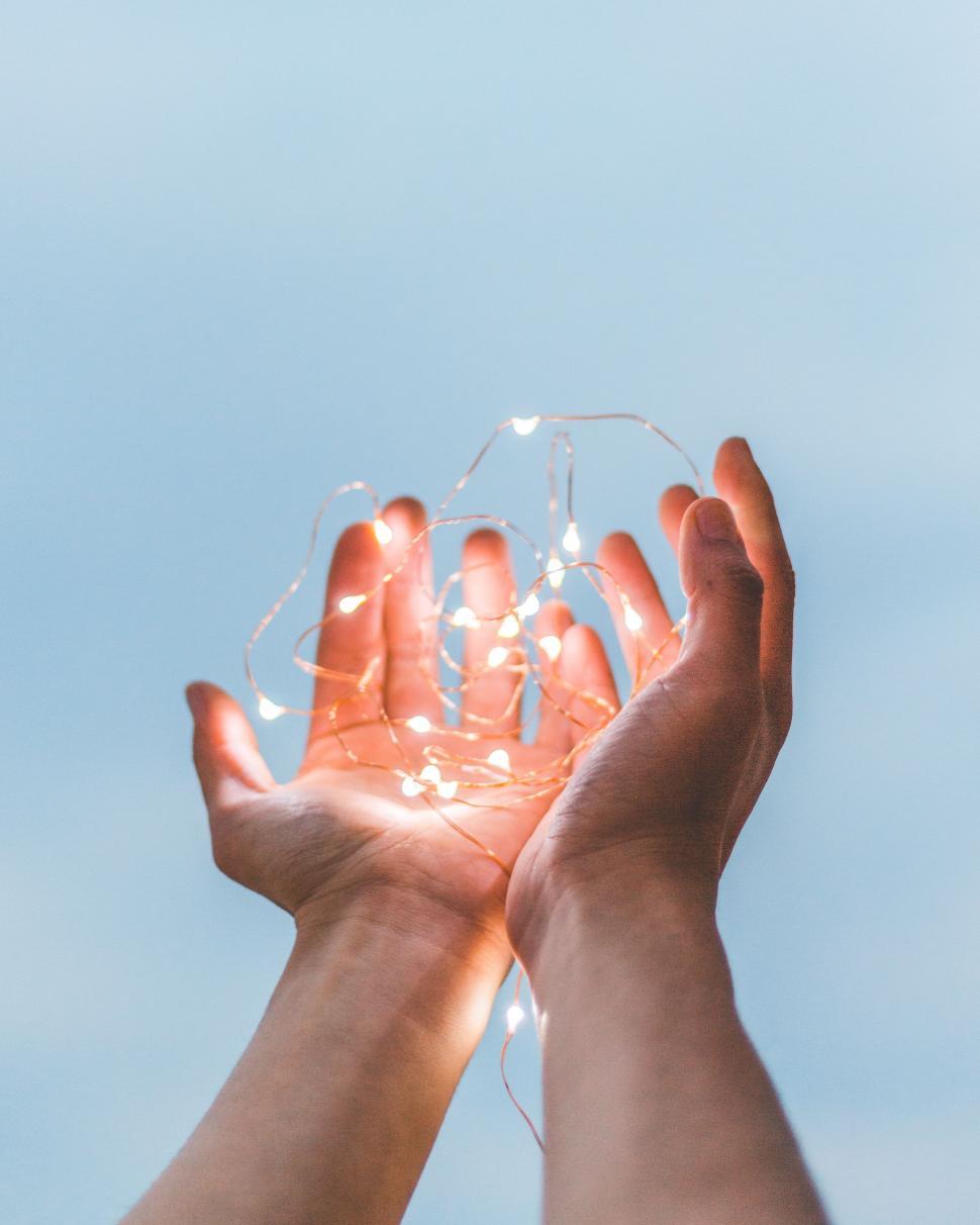 Free Image of Person Holding String of Lights 