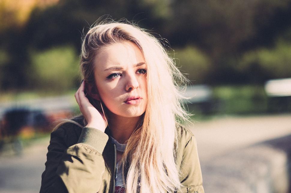Free Image of Woman With Blonde Hair Talking on Cell Phone 