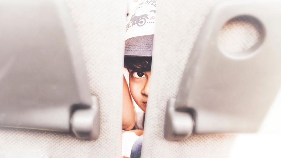 Free Image of Persons Face Seen Through Metal Handles 