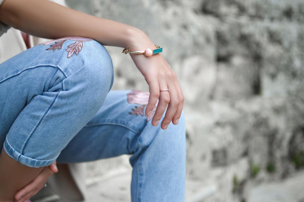 Free Image of Woman Sitting on Bench With Hand on Hip 