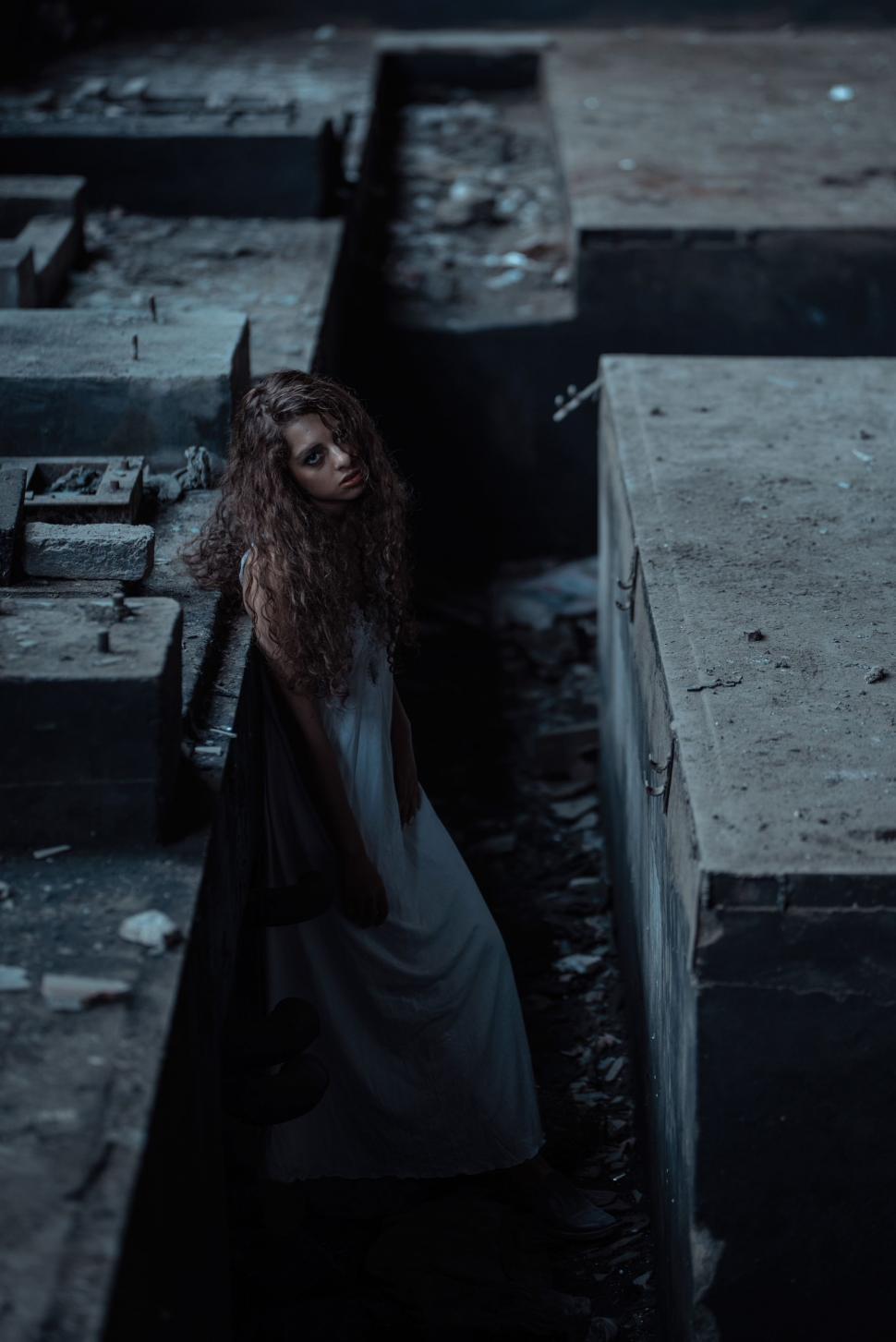 Free Image of Woman With Long Hair Standing Next to a Box 