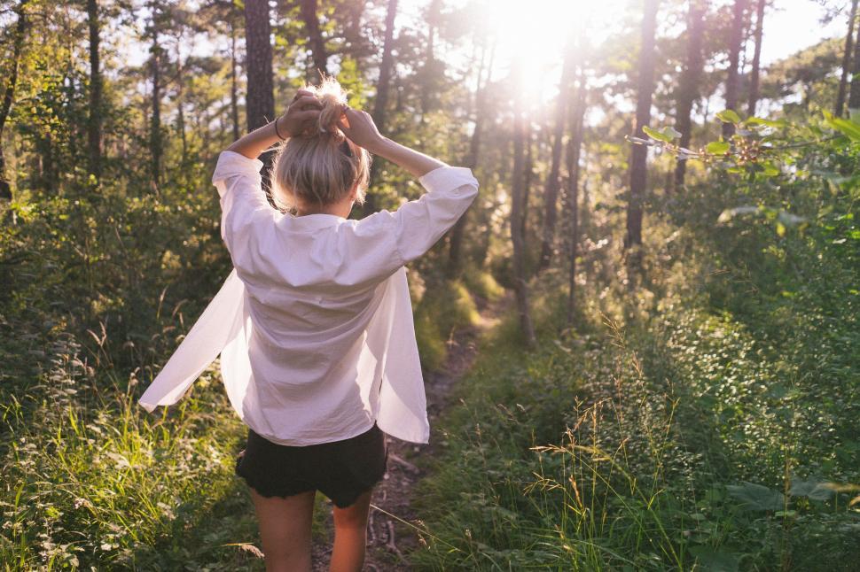 Free Image of Woman Walking Down a Path in the Woods 