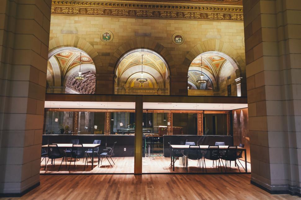 Free Image of Expansive Room With Wooden Floors and Arches 