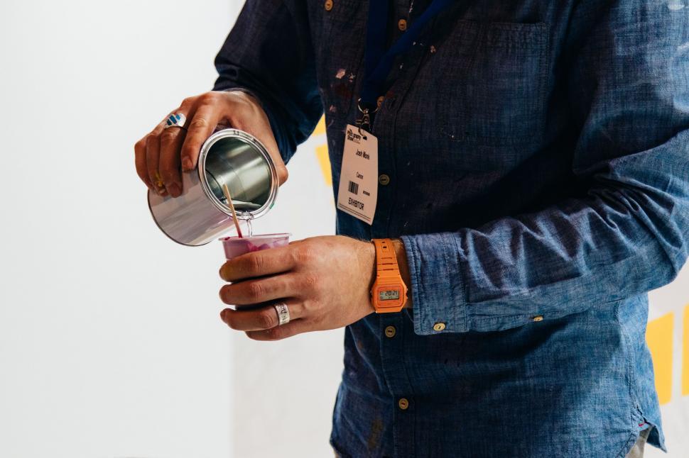 Free Image of Man Pouring Liquid Into Cup 