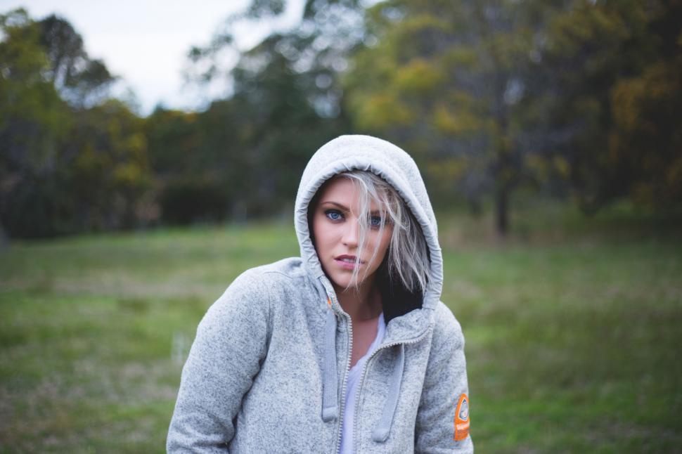 Free Image of Woman in Gray Hoodie Standing in Field 