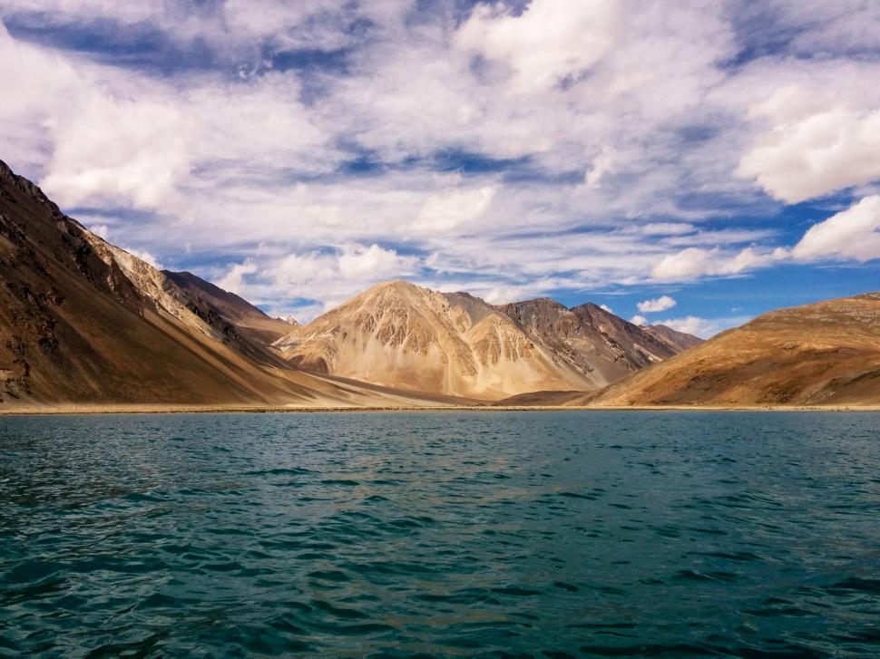 Free Image of Mountain-Encircled Lake Under Cloudy Sky 