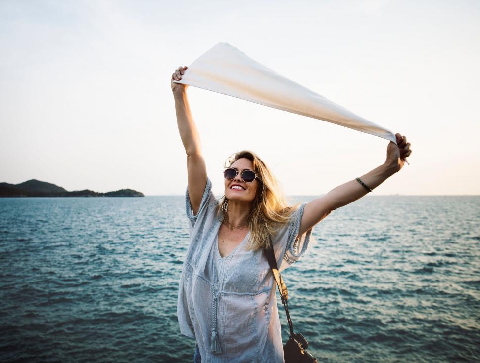 Free Image of Woman Holding White Scarf Over Head 