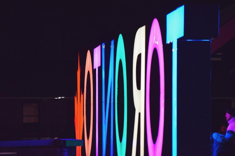 Free Image of Person Standing in Front of Large Sign 