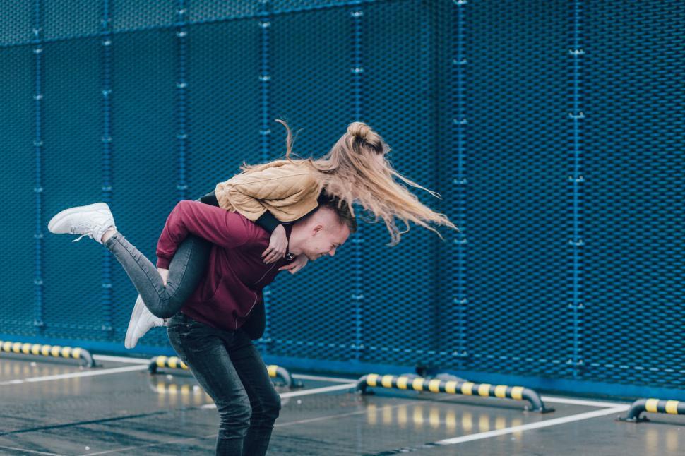 Free Image of Woman Holding Man in the Air 