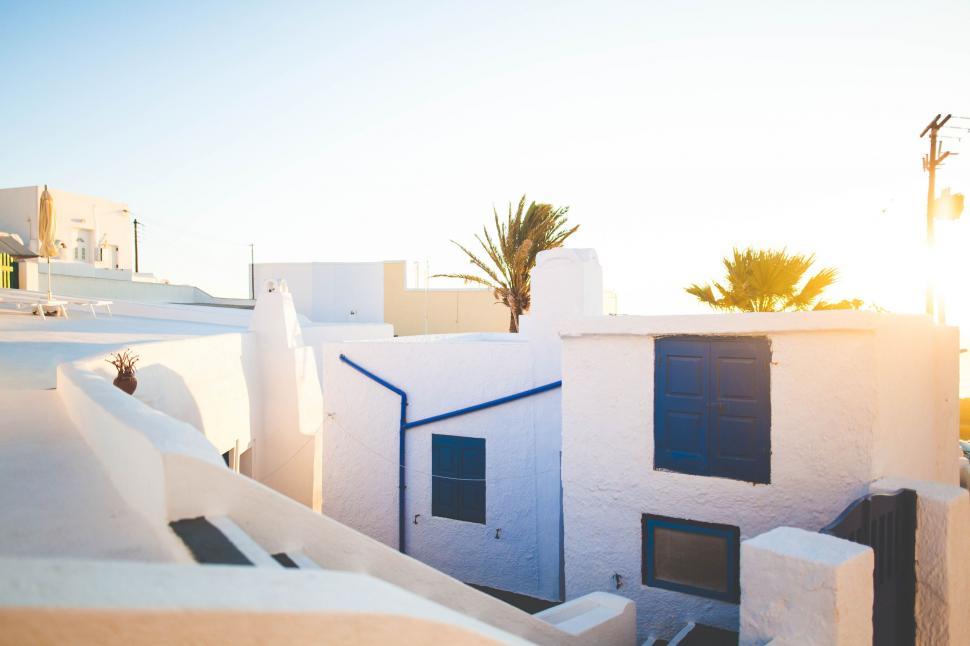 Free Image of White Building With Palm Tree in Background 