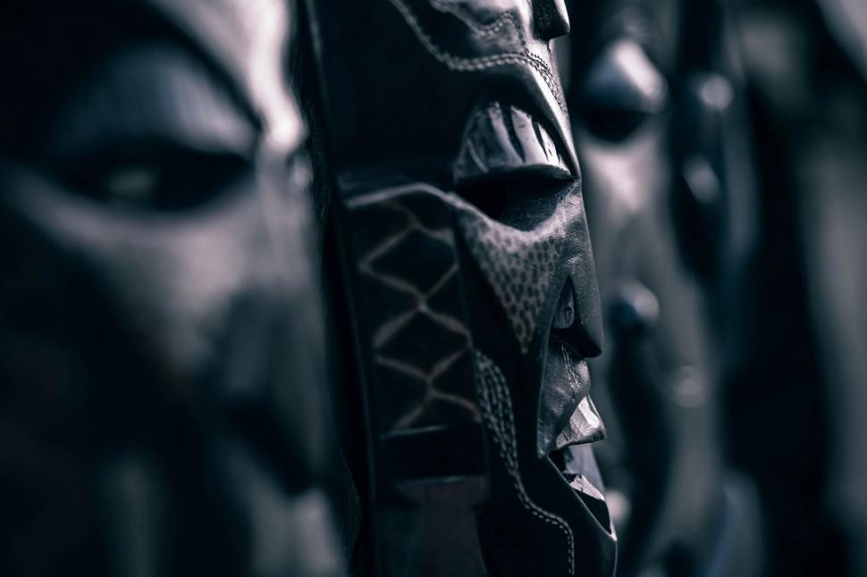Free Image of Close Up of Group of Masks on Wall 