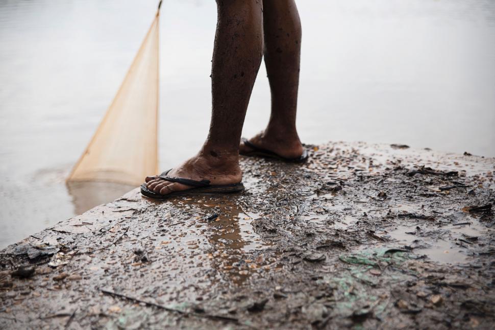Free Image of Person Standing on Rock With Net 