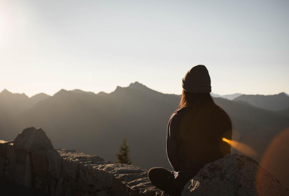 Free Image of Person Sitting on Mountain Overlooking Valley 