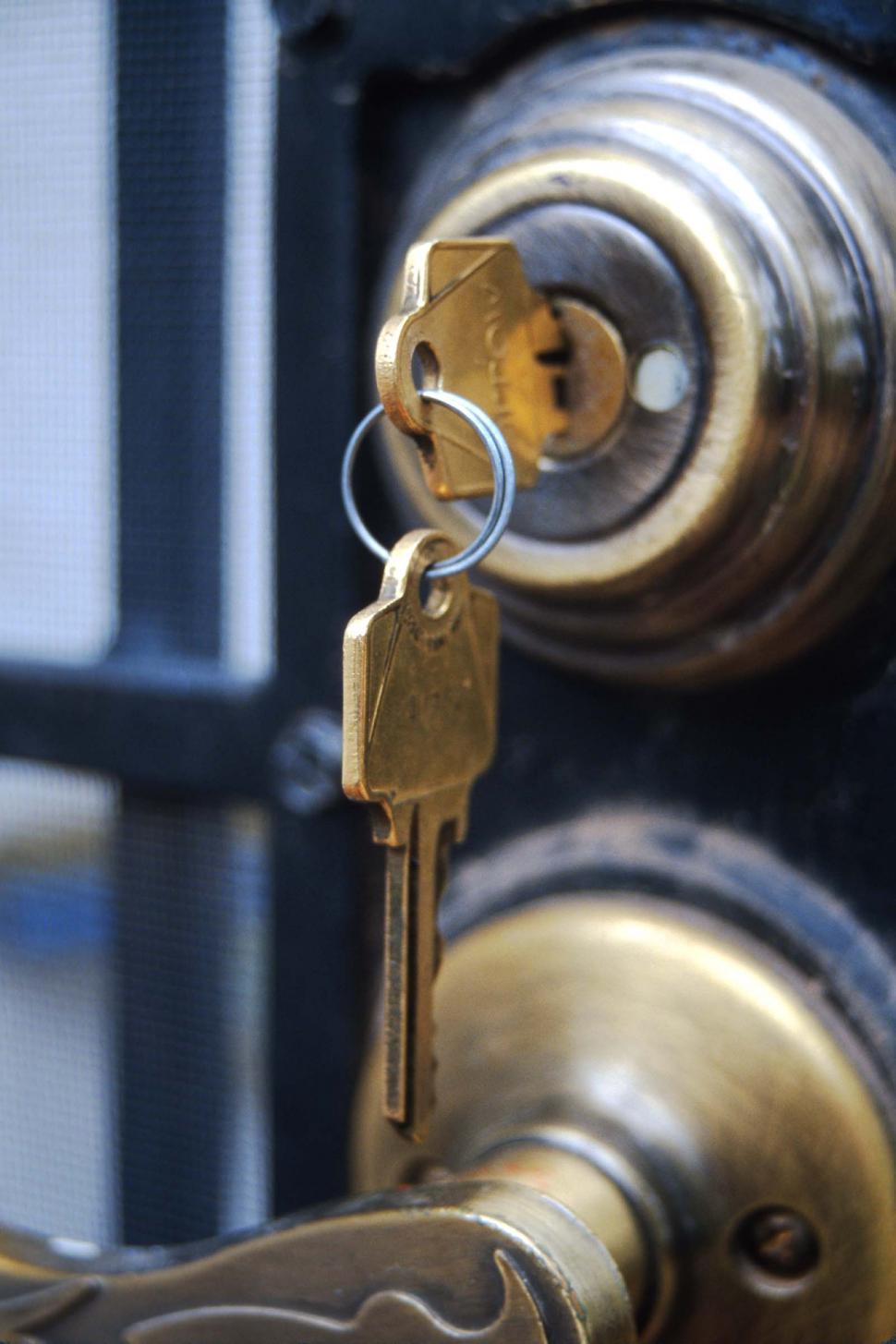 Free Image of Keys hang from deadbolt lock 