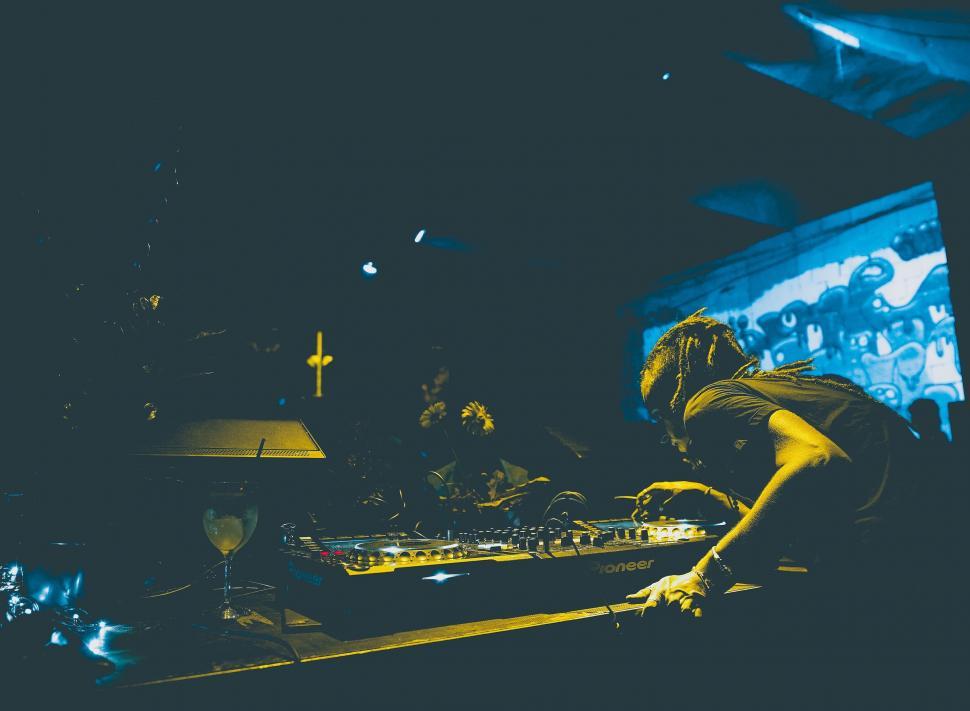 Free Image of DJ Mixing in Front of Large Screen 