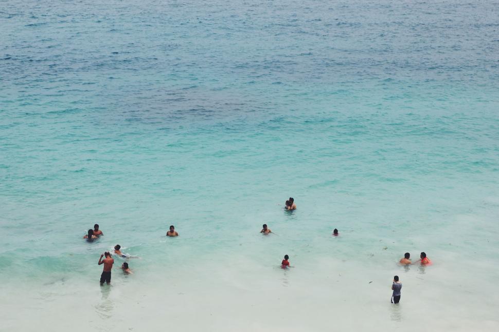 Free Image of Group of People Swimming in the Ocean 