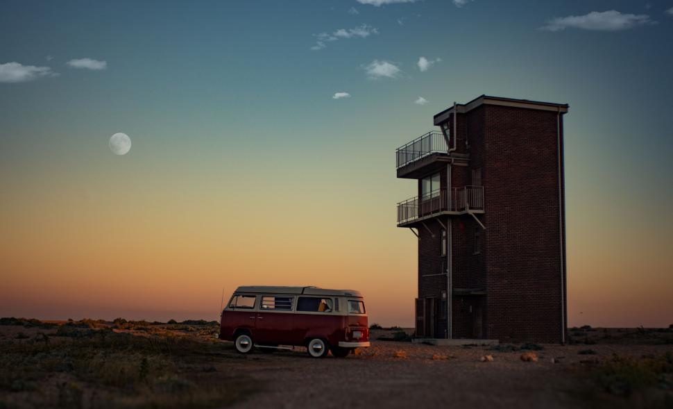 Free Image of Van Parked in Front of Tall Building 