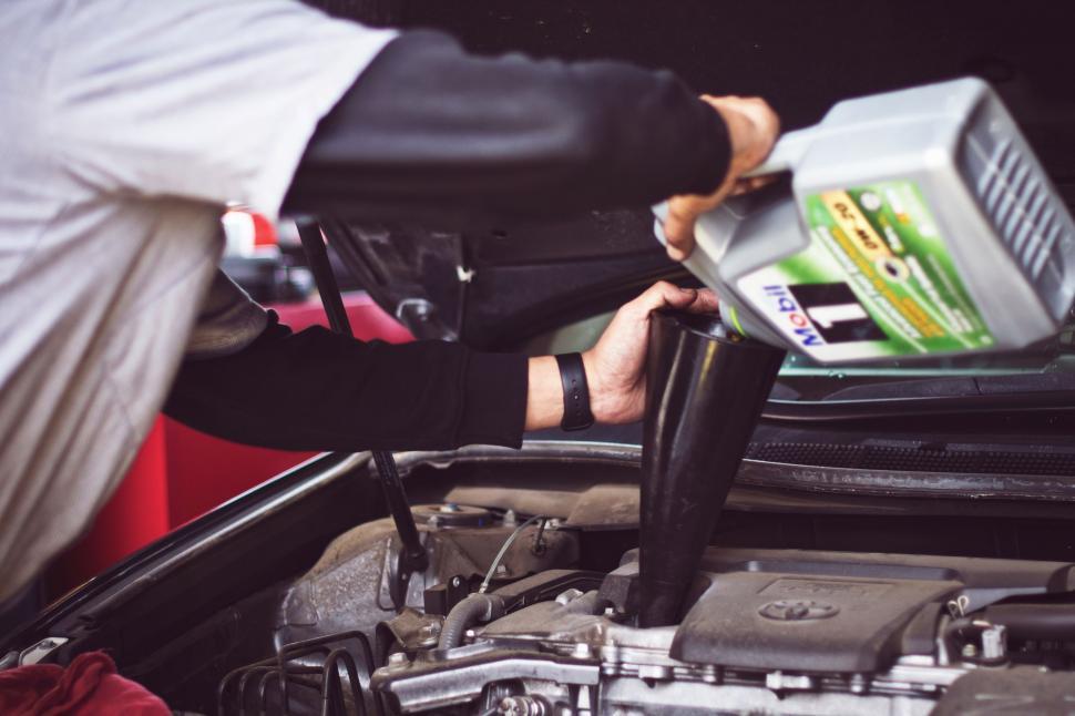 Free Image of Man Working on Car Engine 