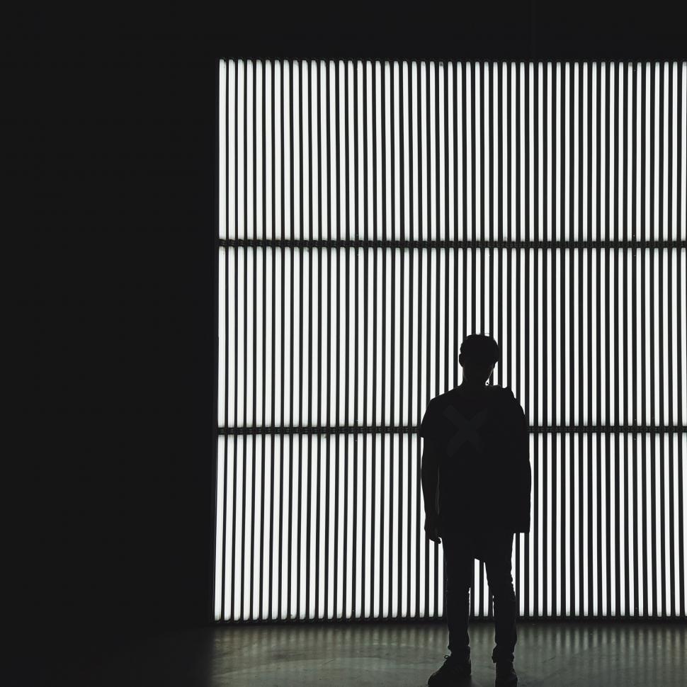 Free Image of Person Standing in Front of Wall 