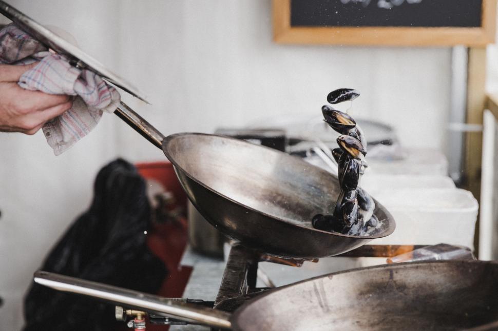 Free Image of Person Holding Spatula Over Wok 