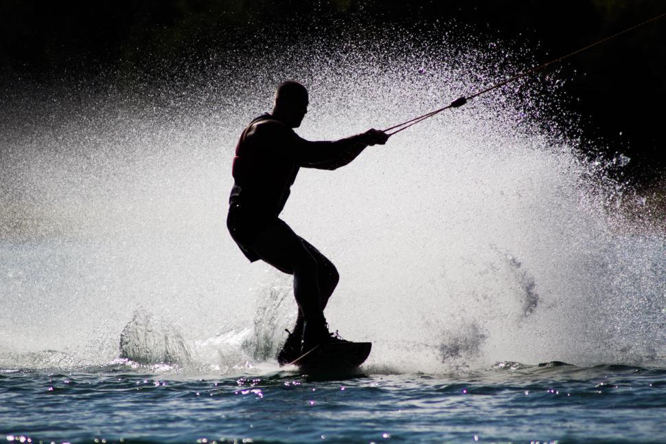 Free Image of Man Riding Wave on Surfboard 