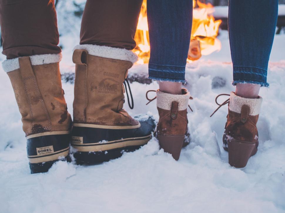 Free Image of Two People Standing Together in the Snow 