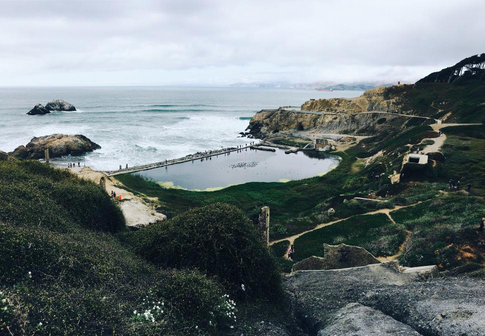 Free Image of Overlooking a Body of Water From a Hill 