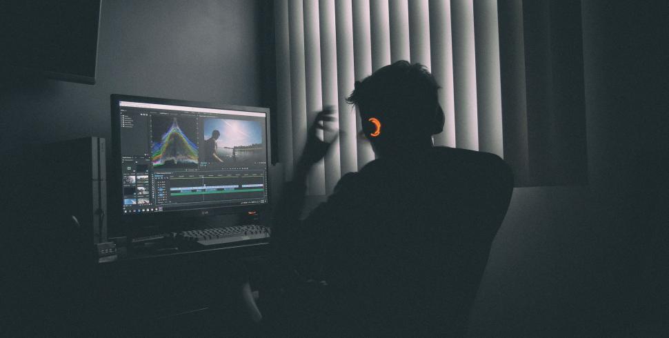 Free Image of Man Sitting in Front of Flat Screen TV 