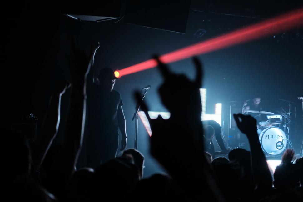 Free Image of Energetic Crowd With Hands Raised at Concert 