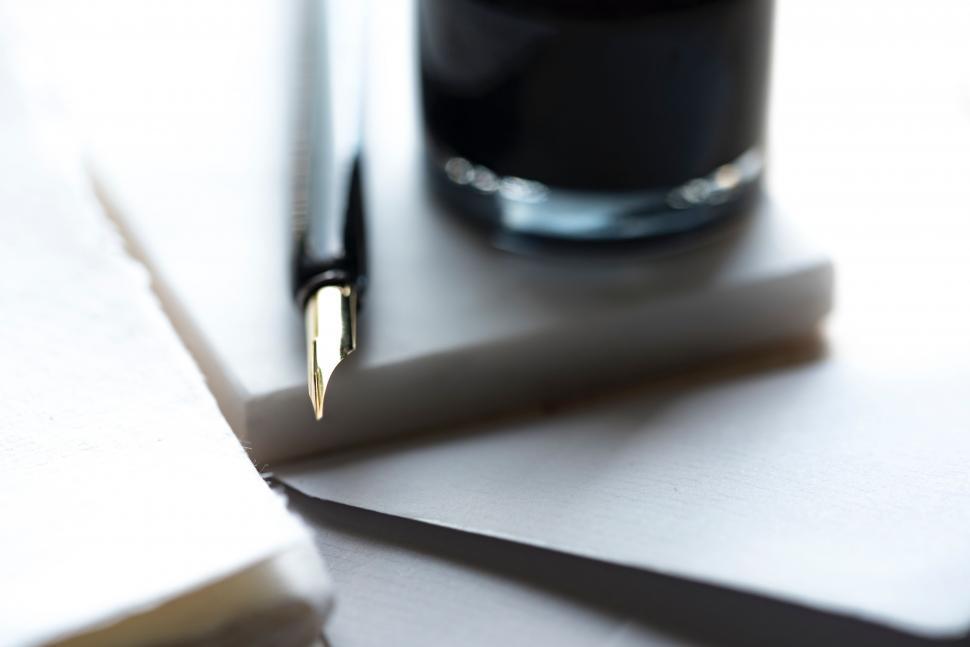 Free Image of Pen Resting on Piece of Paper 