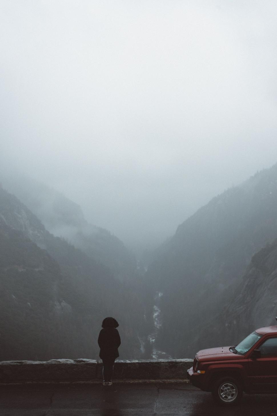 Free Image of Person Standing in Rain Near Car 