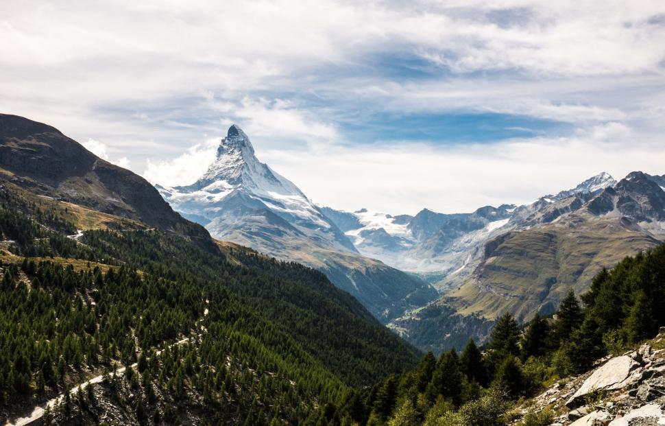 Free Image of Mountain Range With Trees in Foreground 