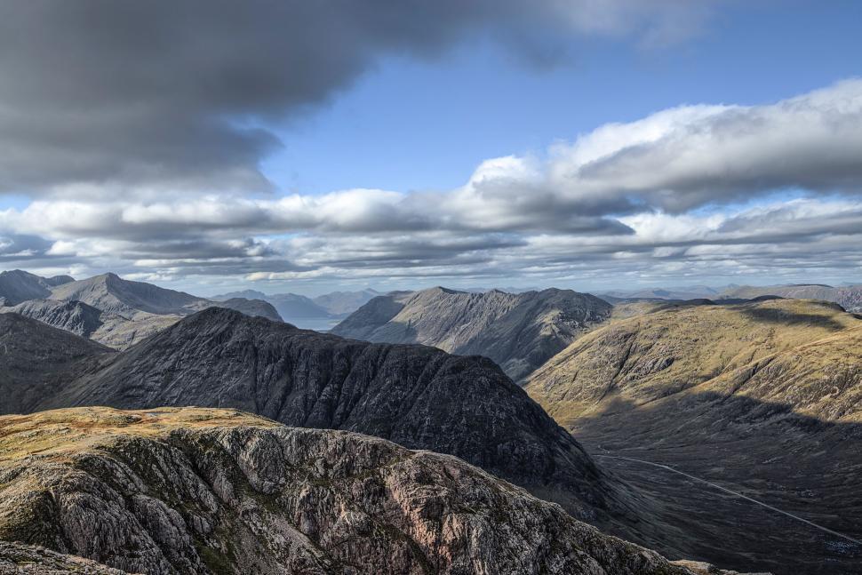 Free Image of A Panoramic View of a Mountain Range From a Hilltop 