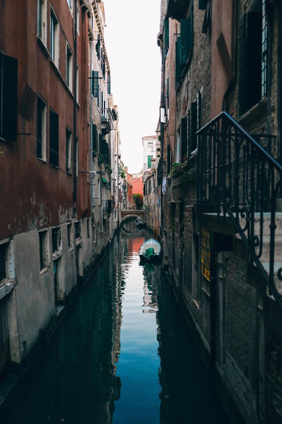 Free Image of Boat Navigating Narrow Canal 