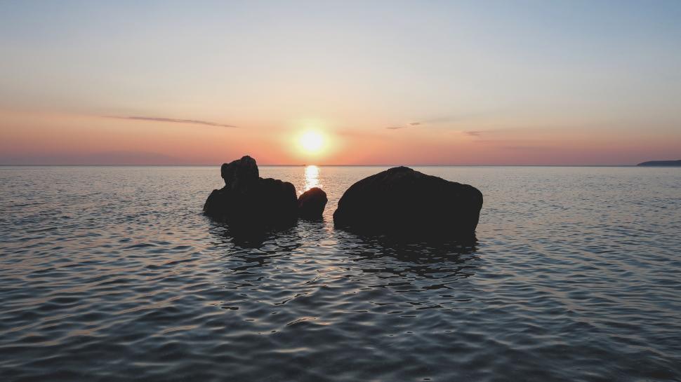 Free Image of Rocks Floating in Middle of Body of Water 
