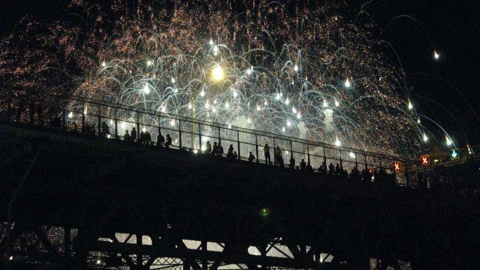 Free Image of Crowded People Standing on Top of a Bridge 