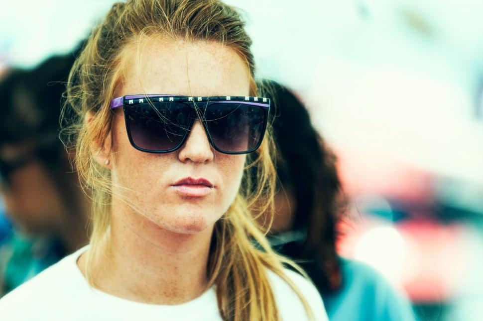 Free Image of Woman Wearing Sunglasses and White Shirt 