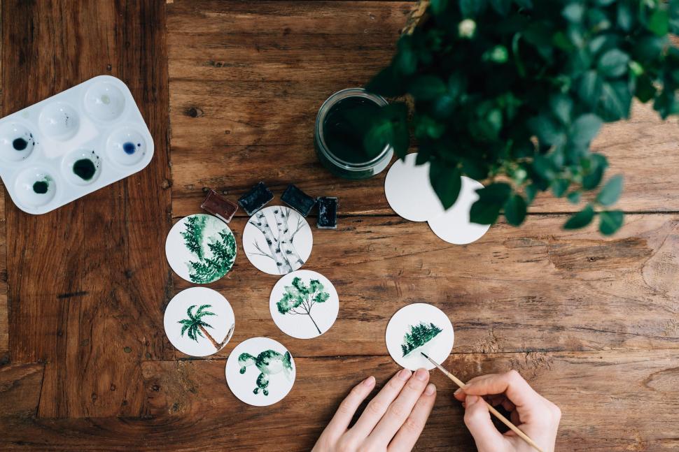 Free Image of Person Painting Picture on Piece of Paper 
