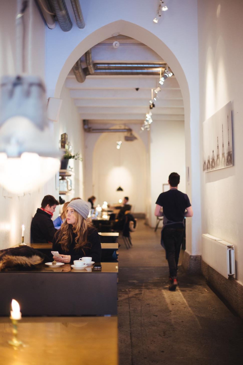Free Image of Group of People Sitting at Tables in a Restaurant 