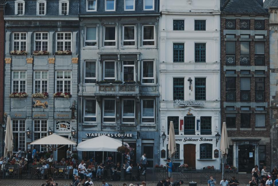 Free Image of Group of People Standing in Front of Tall Buildings 