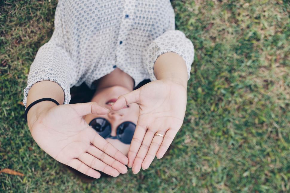 Free Image of Person Holding Hands Together in Grass 