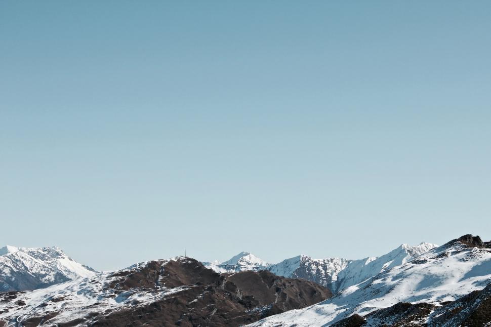 Free Image of Man Snowboarding Down Snow-Covered Slope 
